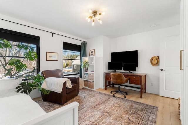 home office with light hardwood / wood-style flooring