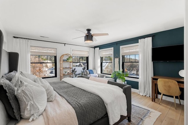 bedroom featuring ceiling fan and light hardwood / wood-style flooring