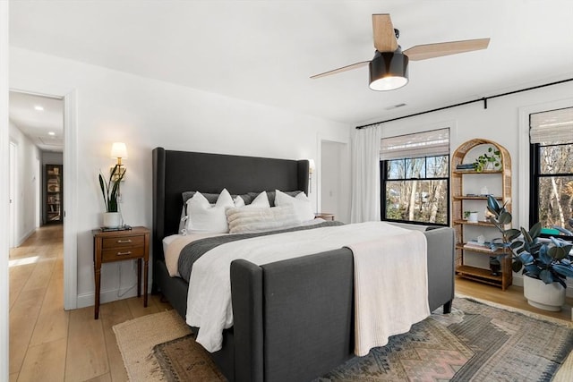 bedroom with ceiling fan and light hardwood / wood-style floors