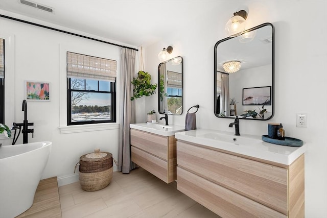 bathroom with vanity and a bath