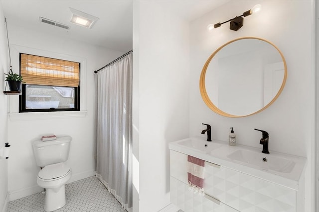 bathroom with vanity, curtained shower, and toilet