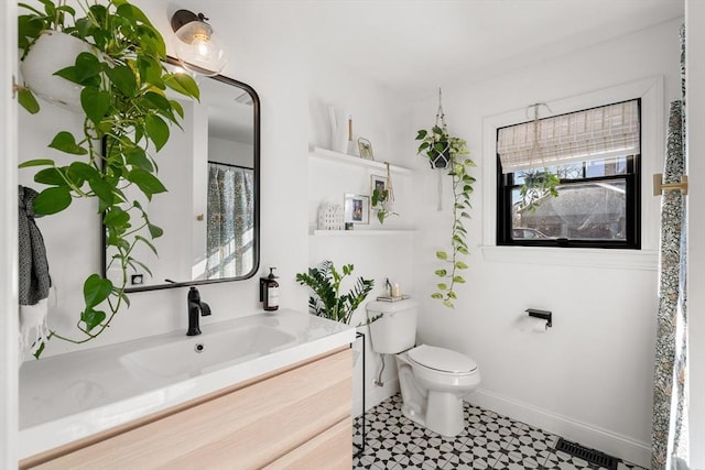 bathroom featuring vanity and toilet