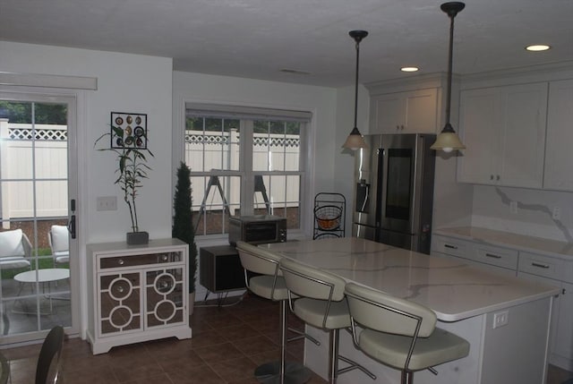 11 Rockingham Dr Unit 11, Tewksbury, MA 01876 - kitchen with stainless steel refrigerator with ice dispenser, dark tile patterned floors, pendant lighting, a kitchen island, and recessed lighting