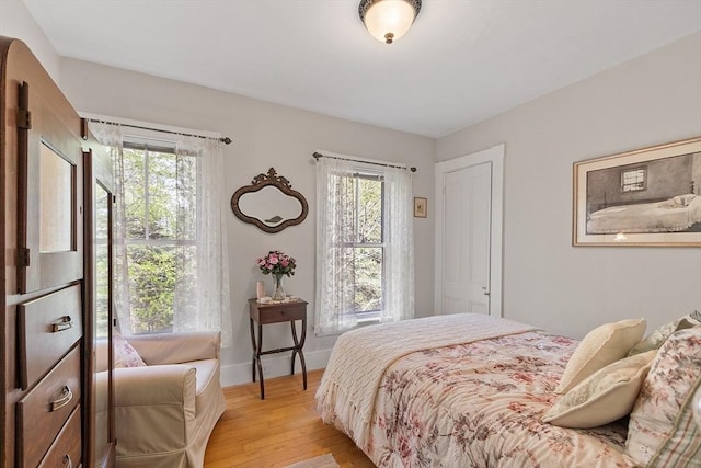 bedroom featuring light wood-type flooring and baseboards