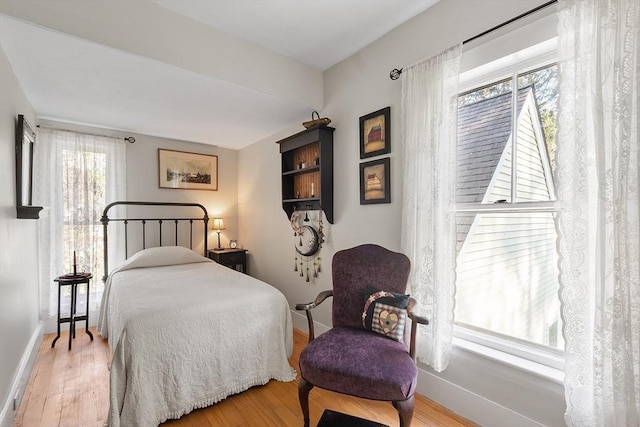 bedroom featuring baseboards and wood finished floors