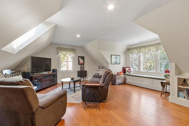 living room featuring recessed lighting, lofted ceiling with skylight, and light wood-type flooring
