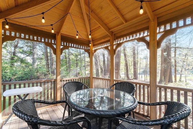 wooden deck featuring a gazebo and outdoor dining area