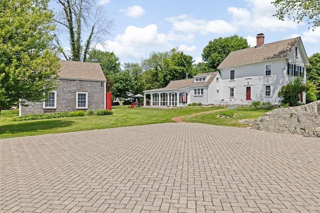 112 Hollett St, Scituate, MA 02066 - view of front facade featuring a sunroom, a front yard, and a chimney