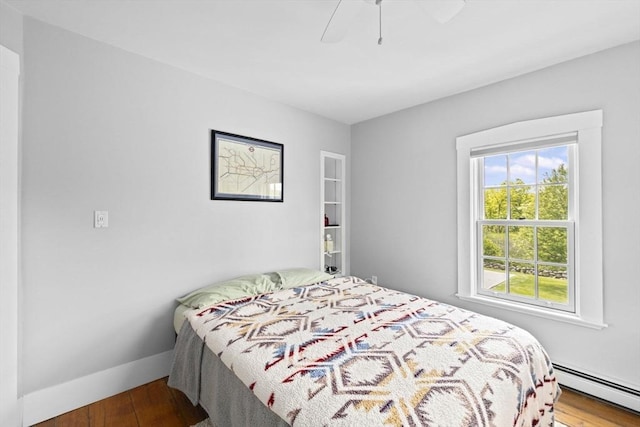112 Hollett St, Scituate, MA 02066 - bedroom with a baseboard heating unit, wood finished floors, and a ceiling fan