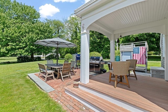 112 Hollett St, Scituate, MA 02066 - wooden terrace featuring outdoor dining space, a lawn, a patio area, and view of scattered trees