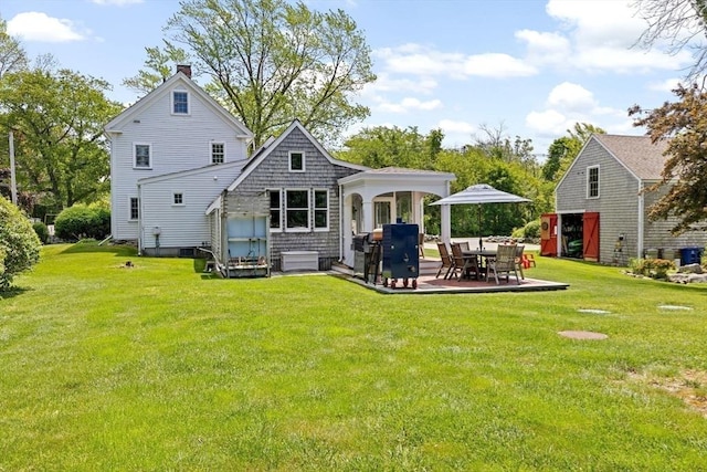 112 Hollett St, Scituate, MA 02066 - rear view of house featuring a chimney, a lawn, and a patio