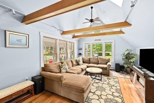 112 Hollett St, Scituate, MA 02066 - living room featuring rail lighting, wood finished floors, a ceiling fan, and baseboard heating
