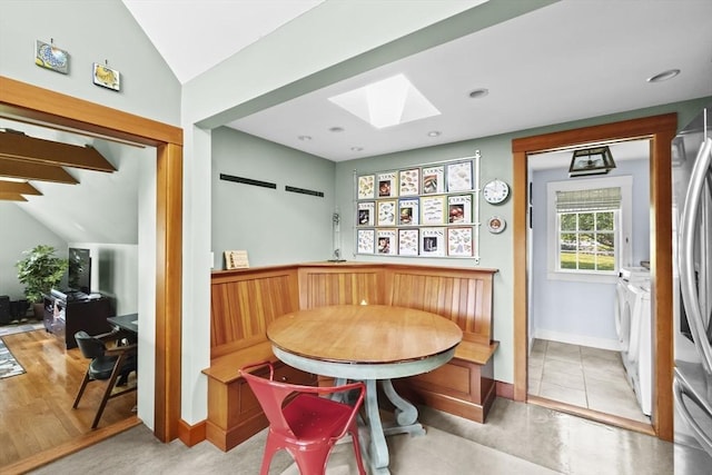 112 Hollett St, Scituate, MA 02066 - dining area featuring a skylight, vaulted ceiling, and baseboards