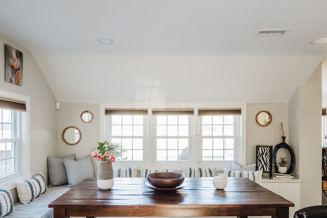 dining area featuring vaulted ceiling