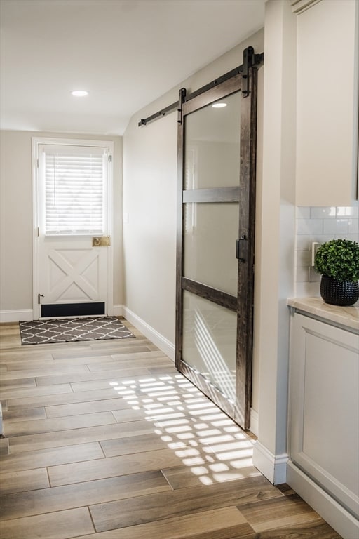 doorway featuring light hardwood / wood-style flooring and a barn door