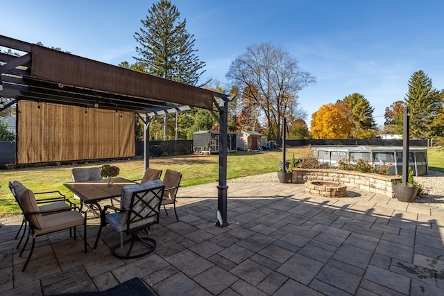 view of patio / terrace with a fire pit and a pergola