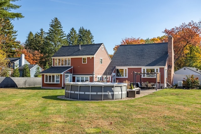 back of house featuring a yard