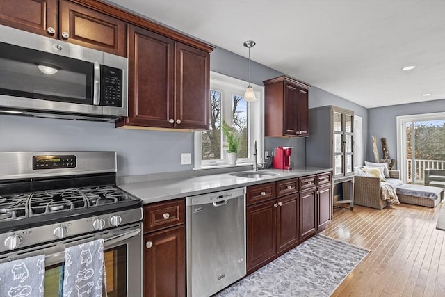 kitchen with a healthy amount of sunlight, appliances with stainless steel finishes, light countertops, and a sink