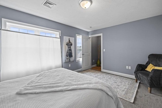 bedroom with visible vents, carpet flooring, and baseboards