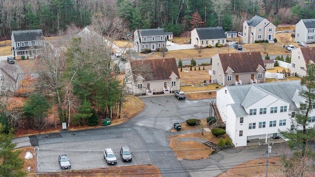 bird's eye view with a wooded view and a residential view