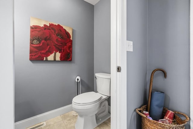 bathroom featuring tile patterned flooring, visible vents, toilet, and baseboards