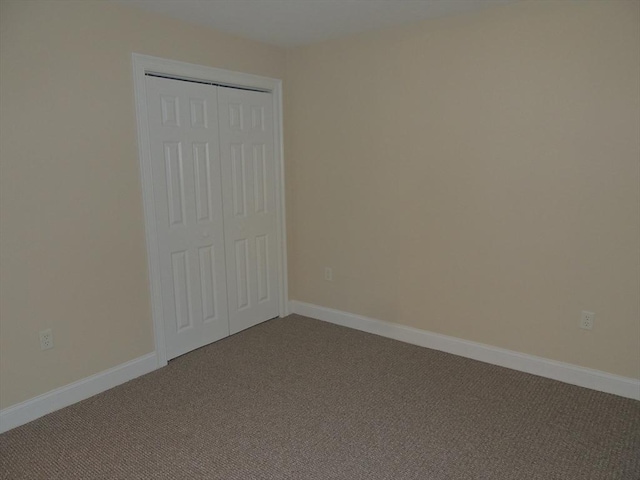 unfurnished bedroom featuring a closet and carpet