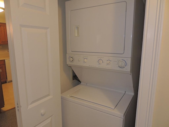 laundry area featuring stacked washer / drying machine