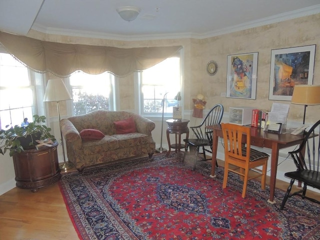 sitting room with hardwood / wood-style floors and crown molding