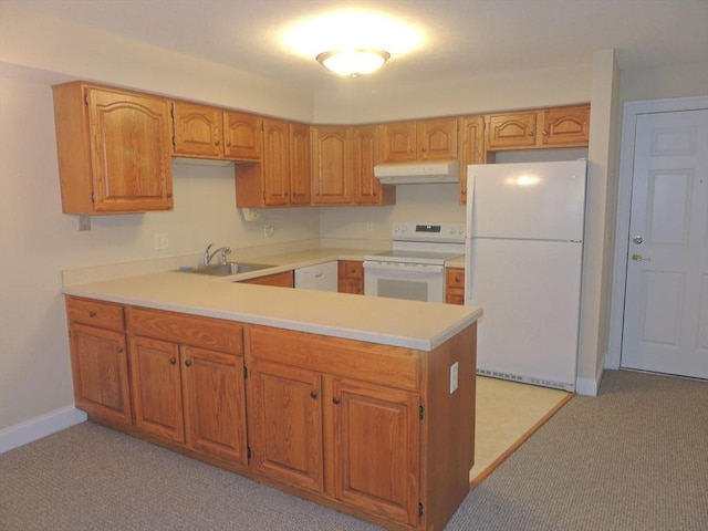 kitchen with white appliances, sink, and light carpet