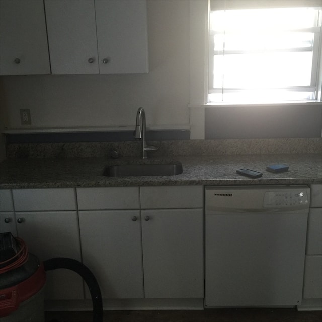 kitchen with white cabinetry, sink, and white dishwasher