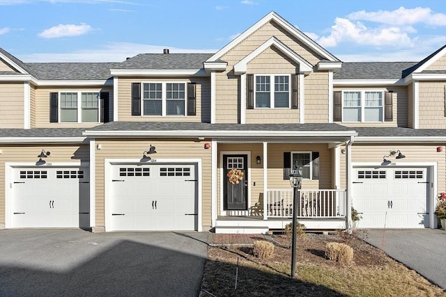 view of property featuring a porch and a garage