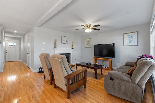 living room featuring ceiling fan and light hardwood / wood-style floors