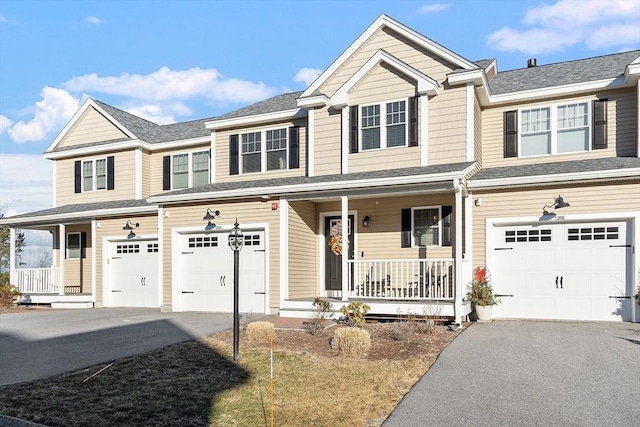 multi unit property featuring covered porch and a garage