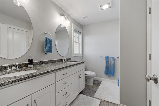 bathroom with tile patterned floors, vanity, and toilet