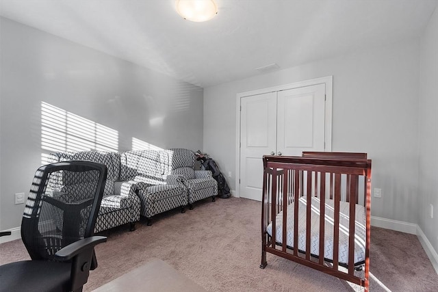 bedroom featuring a closet and light colored carpet