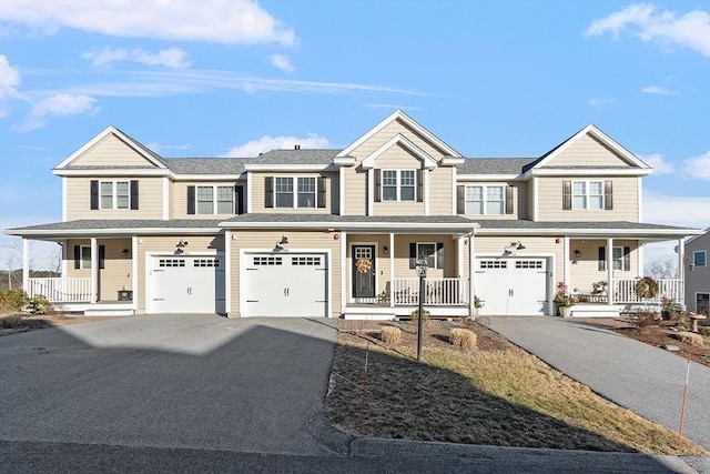 multi unit property with covered porch and a garage