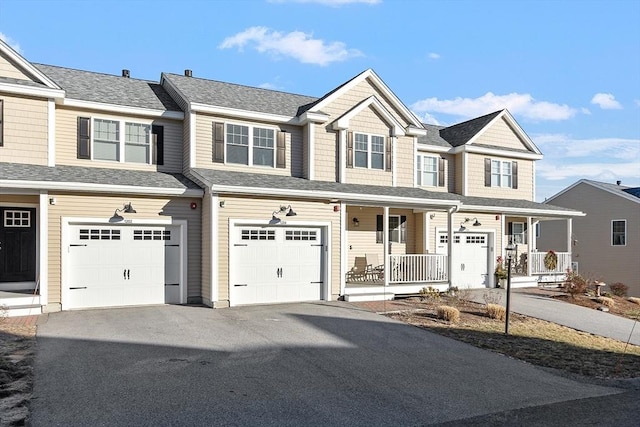 townhome / multi-family property with a porch and a garage