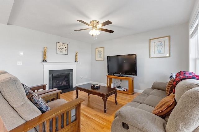 living room with light wood-type flooring and ceiling fan