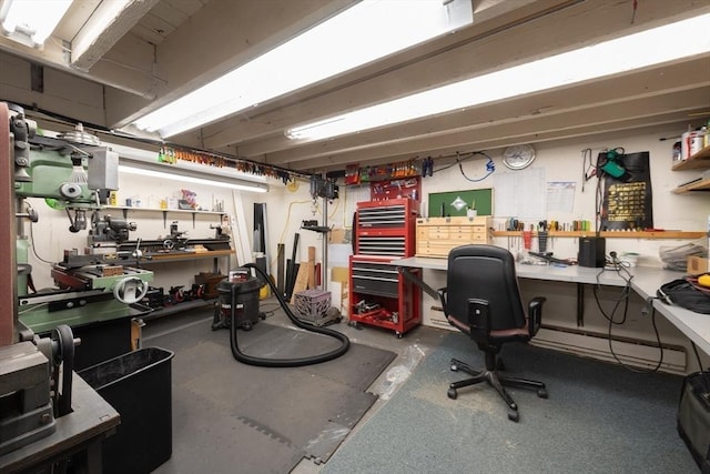 interior space featuring baseboard heating and a workshop area