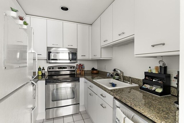 416 Marlborough St Unit 504, Boston, MA 02115 - kitchen with a sink, appliances with stainless steel finishes, white cabinets, and light tile patterned floors
