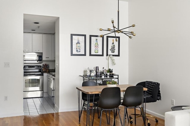 416 Marlborough St Unit 504, Boston, MA 02115 - dining room featuring baseboards, wood finished floors, and a chandelier