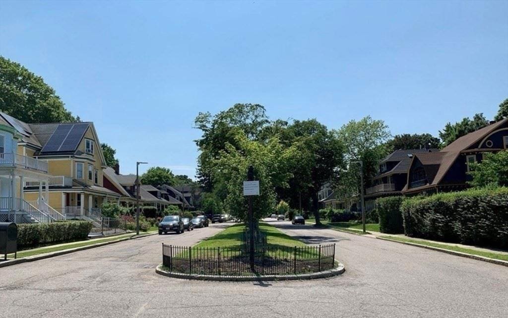 view of road with a residential view, curbs, and sidewalks