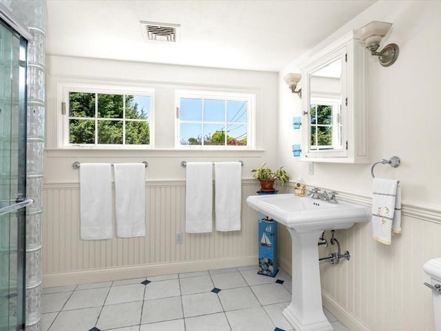 151 Pilgrim Rd, Weymouth, MA 02191 - bathroom with a wainscoted wall, a shower with door, tile patterned floors, and baseboards