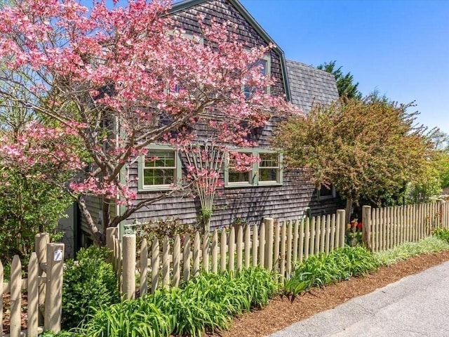 151 Pilgrim Rd, Weymouth, MA 02191 - view of side of property with fence and a shingled roof