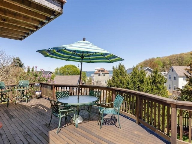 151 Pilgrim Rd, Weymouth, MA 02191 - wooden deck featuring outdoor dining area and a residential view