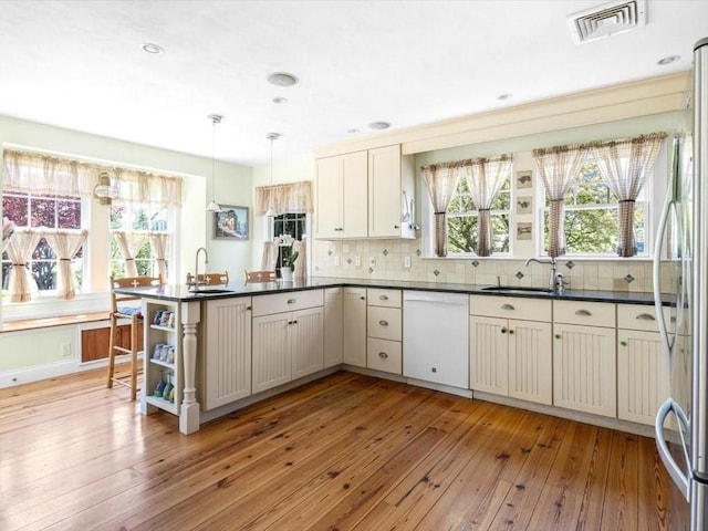 151 Pilgrim Rd, Weymouth, MA 02191 - kitchen with white dishwasher, a sink, light wood finished floors, and recessed lighting