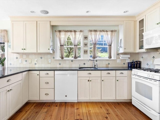 151 Pilgrim Rd, Weymouth, MA 02191 - kitchen with white appliances, a sink, backsplash, and light wood-style floors