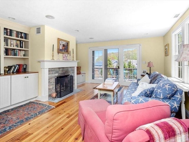 151 Pilgrim Rd, Weymouth, MA 02191 - living room featuring wood finished floors, a fireplace, french doors, and built in shelves