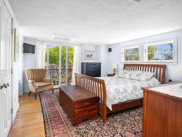 151 Pilgrim Rd, Weymouth, MA 02191 - bedroom featuring access to exterior, multiple windows, and light wood-style flooring