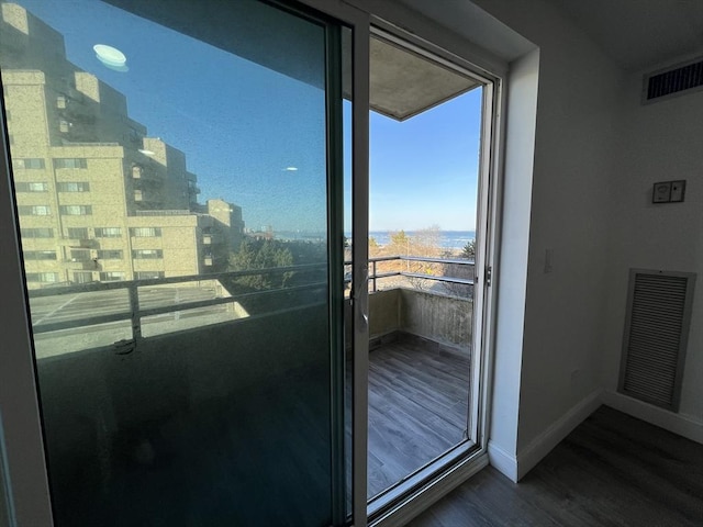 balcony with visible vents and a view of city